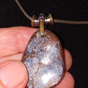 Boulder Opal necklace with 24" sterling silver chain. Bale is silver 2 sapphires